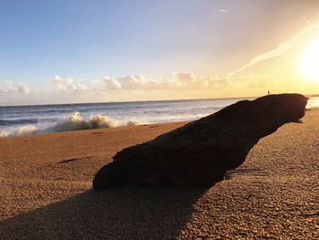 Scenic view of beach against sky during sunset