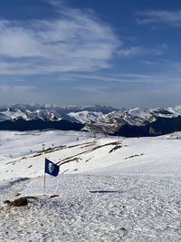 Snow covered land and mountains against sky