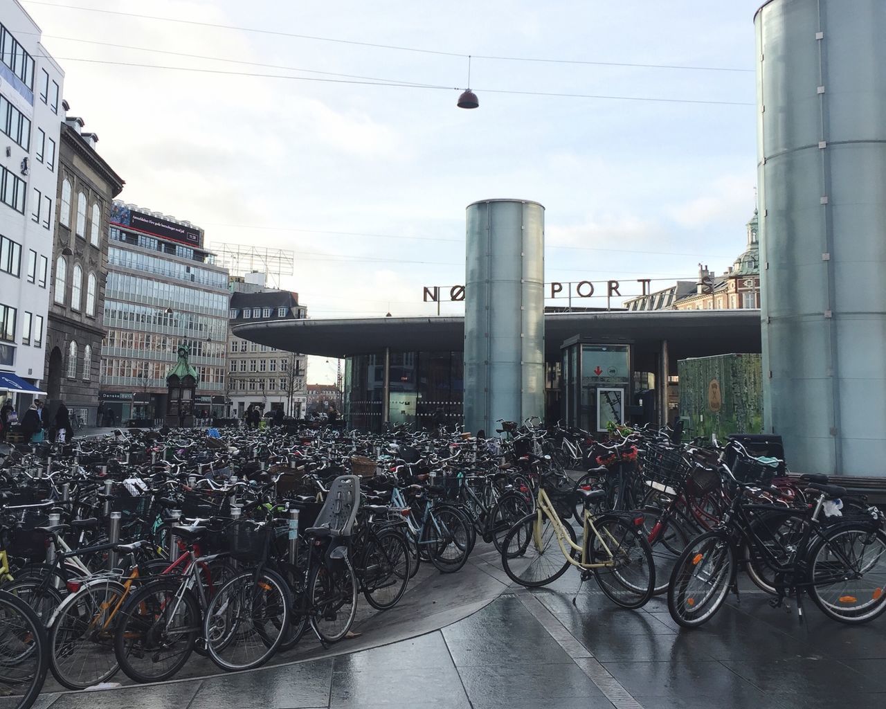 BICYCLES PARKED ON STREET AGAINST BUILDING