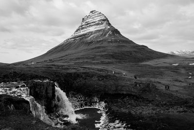 Scenic view of waterfall against sky