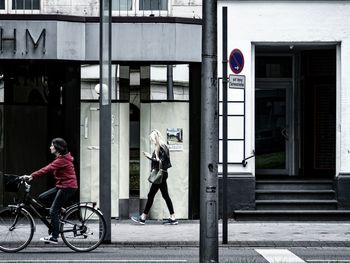 People walking on sidewalk in city