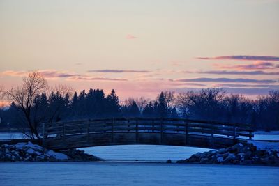 Scenic view of river against sky at sunset