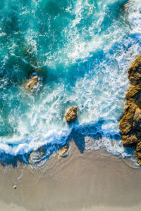 Aerial image of waves hitting the coastline of the french island corse near the village lumio.