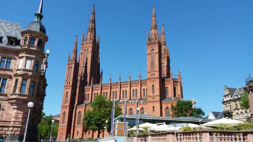 Low angle view of buildings against blue sky