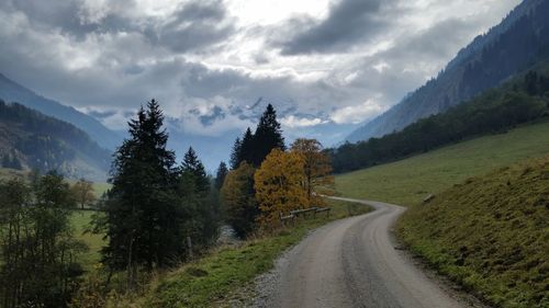 Empty road leading towards mountains