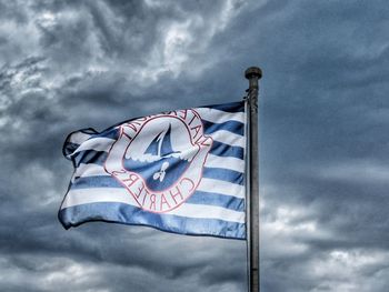 Low angle view of flag against sky