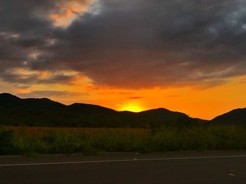 Scenic view of silhouette mountains against sky during sunset