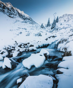 Scenic view of snow covered mountains against sky