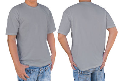 Rear view of friends standing against white background