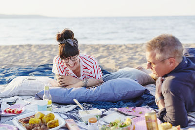 Couple having picnic on beach