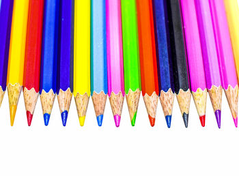 Close-up of colored pencils against white background