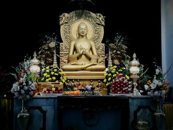 Statue of buddha against temple