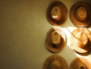 Close-up of hat on table against wall