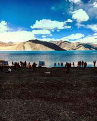 People on beach against sky