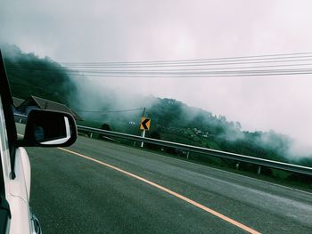 Man on road against sky