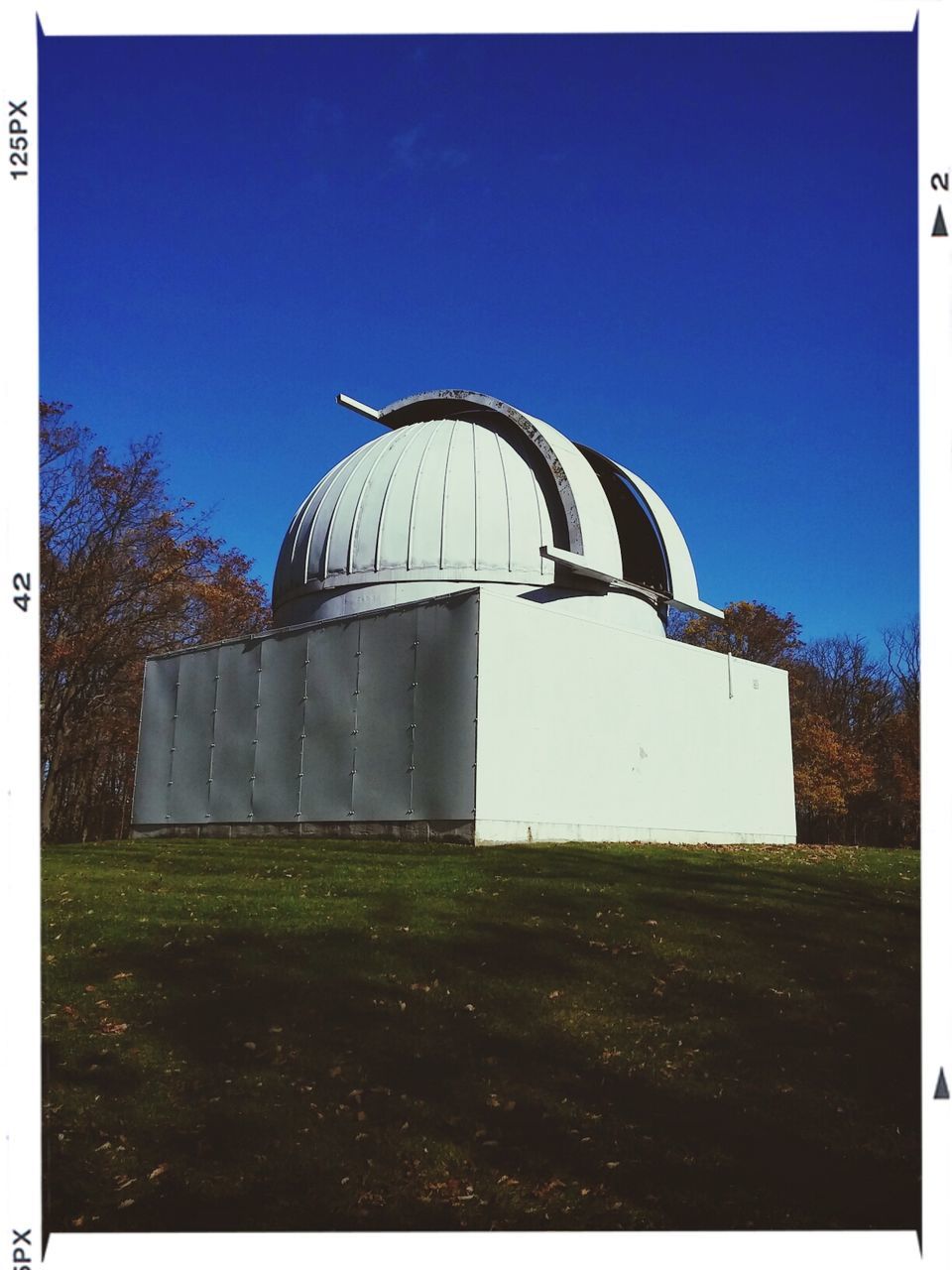 architecture, built structure, building exterior, clear sky, blue, transfer print, grass, auto post production filter, copy space, low angle view, history, sky, day, old, outdoors, tower, field, exterior, tree, no people