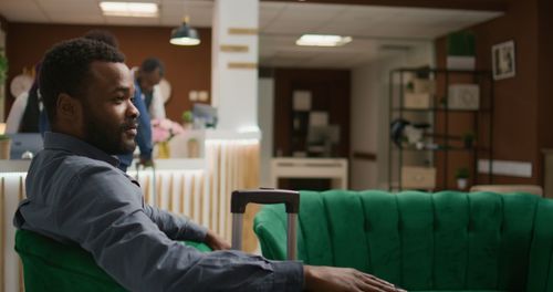 Side view of man sitting in cafe