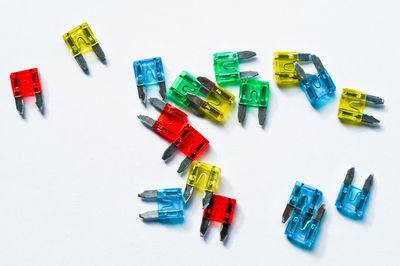 High angle view of colored pencils on white background