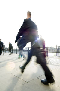 People walking against clear sky