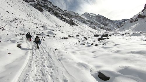 People walking on snow covered mountain