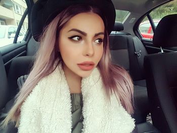 Beautiful young woman in car