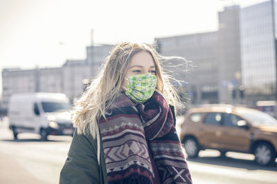 Portrait of woman standing on street in city