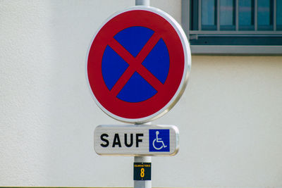 Close-up of road sign on wall