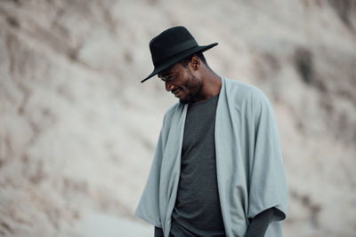 Man looking away while standing on land