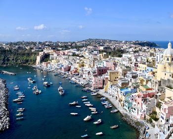 High angle view of townscape by sea against sky