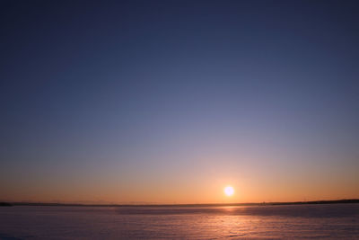 Scenic view of sea against clear sky during sunset