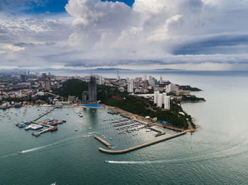 High angle view of buildings by sea against sky