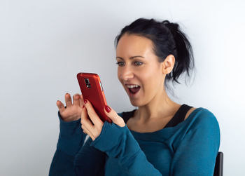 Portrait of smiling young woman using smart phone