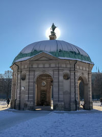 View of sculpture against clear blue sky during winter