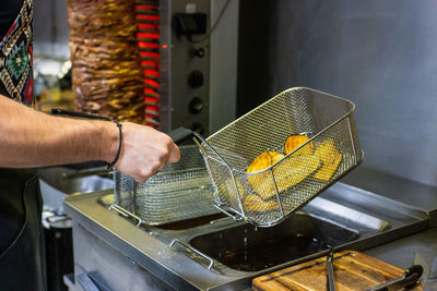 Cropped hand of man preparing food