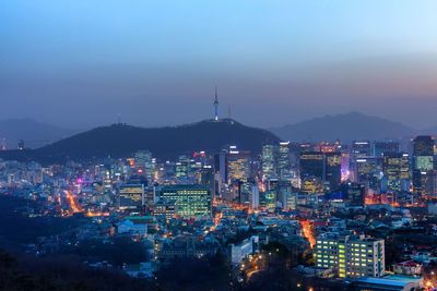 High angle view of city lit up at night