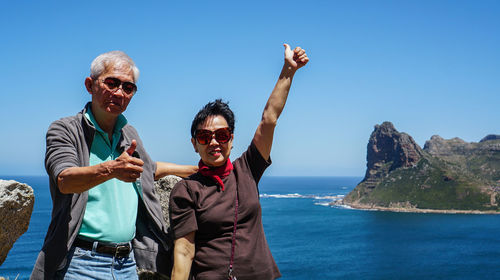 Asian senior couple travel anniversary trip in south africa beautiful  sea and sky beach coastline