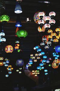 Low angle view of illuminated lanterns hanging at night