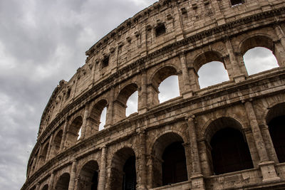 Low angle view of historical building against cloudy sky