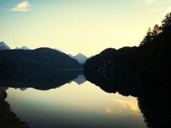 Scenic view of calm lake against sky during sunset