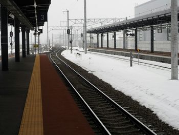 Railway tracks at railroad station during winter