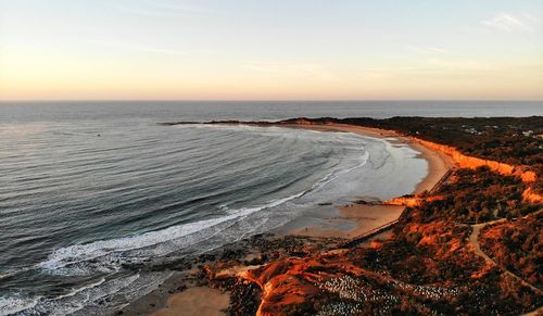 Scenic view of beach against sky during sunset