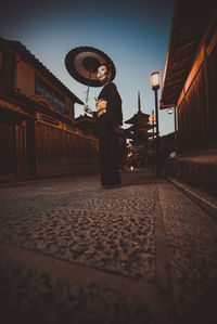 Man standing on railroad track by train