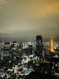 Illuminated cityscape against sky at night