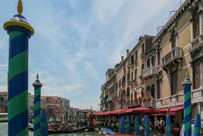 Low angle view of buildings by street against sky