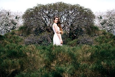 Full length of woman standing on grass