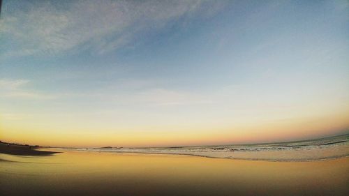 Scenic view of beach against sky during sunset