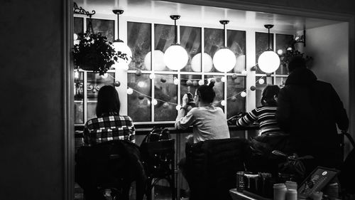 Rear view of people standing in restaurant