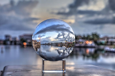 Crystal ball view of sunrise at a waterway of venetian bay in naples, florida at sunrise.