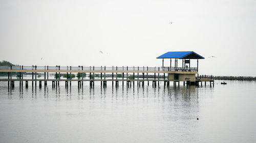 Pier over sea against clear sky