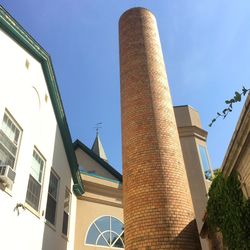 Low angle view of building against clear blue sky